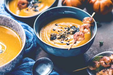 Roasted pumpkin and carrot soup with cream and pumpkin seeds 