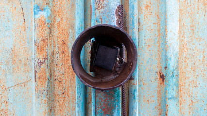 Rusty texture on a metal container that is on the street all year round.