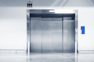 Metallic Doorway of Modern Elevator in Office Building, Architecture Contemporary of Door Lift and Interior Lighting Decorative. Electronic Control Panel and Flooring Symbol Signage of Elevator