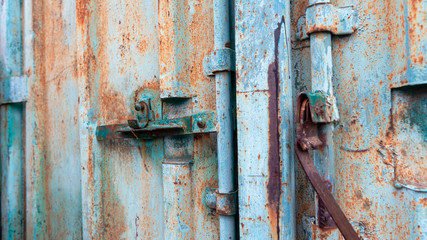 Rusty texture on a metal container that is on the street all year round.