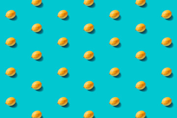 Yellow lemons pattern on a blue background flat lay. Top view. Concept.