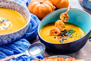 Roasted pumpkin and carrot soup with cream and pumpkin seeds 