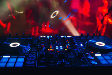 Obraz premium DJ mixer for mixing music and sound in a nightclub at a party