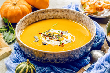 Roasted pumpkin and carrot soup with cream and pumpkin seeds 