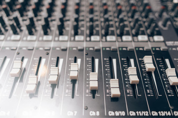 Audio equalizer close up. Studio audio volume mixer. Professional audio equipment.