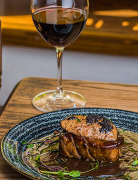 glass of red wine on wooden table