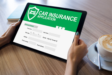 Car insurance application form on screen. Internet and business concept.
