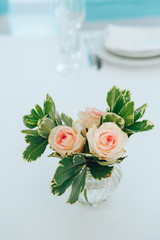 Beautiful fresh roses in a glass vase on a table