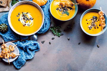 Roasted pumpkin and carrot soup with cream and pumpkin seeds 