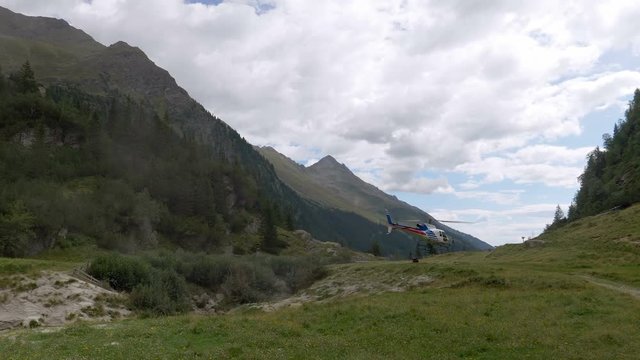 A rescue helicopter taking off in mountain