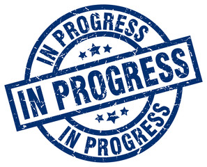 in progress blue round grunge stamp