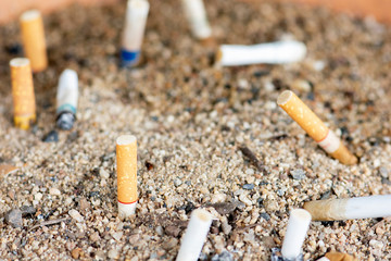 Smoked cigarettes in sand