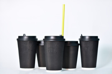Disposable paper cups in black on a white background. Paper cups for hot coffee. Coffee to go. Paper cup for coffee