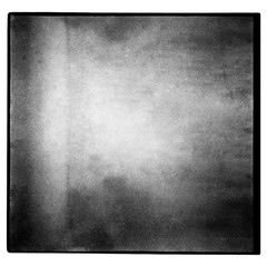 Black and white medium format film background with grain and light leak. Blurry unfocused...