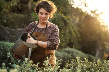 Woman taking care of the flowers at her countryside home © Rawpixel.com