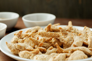 Raw dry soya meat chunks on a white plate, macro shot