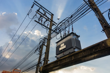 Electrical transformer, High voltage power transformer in town with sky on evening background