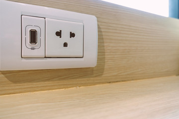 Public USB charger and power outlets on wooden table