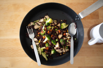 Healthy black fired rice chicken breast on hot pan.