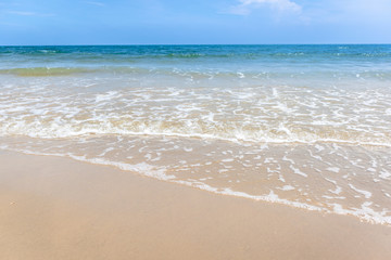 Fototapeta na wymiar Tropical beach with green ocean and small wave.