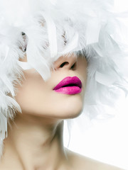 white feathers. young sexy woman with pink lips