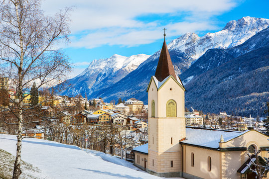Scenic view on Scuol village and valley on a sunny winter day, Lower Engadine, Switzerland.
