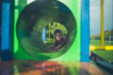 Toddler hiding in pipe at playground