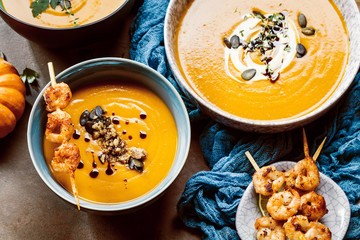 Roasted pumpkin and carrot soup with cream and pumpkin seeds 