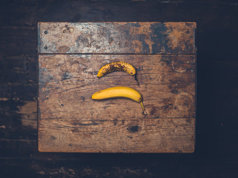 Overhead shot of two bananas on wooden table