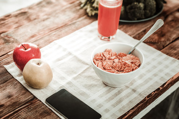 Healthy breakfast. Close up of a bowl with tasty useful cereal standing on the table