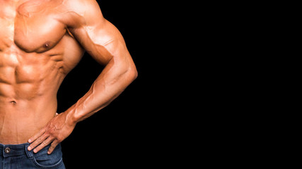 Strong Athletic Man Fitness Model Torso showing six pack abs. isolated on black background.