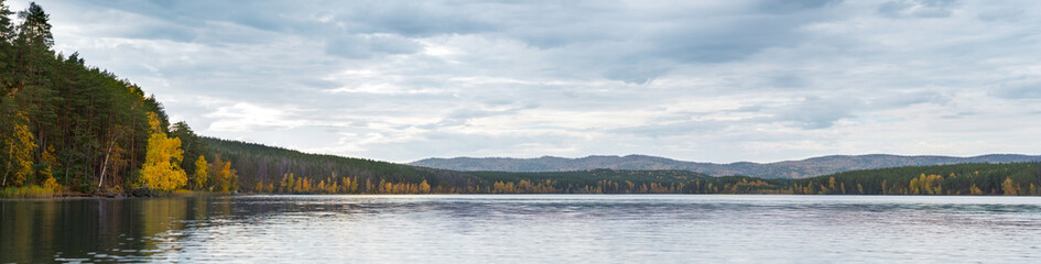 Panoramic view of lake and mountains on the background, autumn