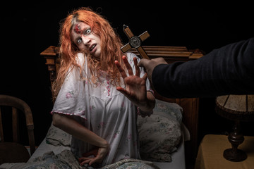 Scary woman possessed by devil in the bed. Exorcism of priest.