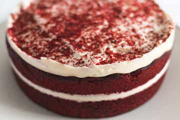 Red and white red velvet cake close up on a white background