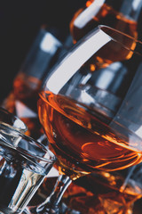 Set of strong alcoholic drinks in glasses and shot glass in assortent: vodka, rum, cognac, tequila,...