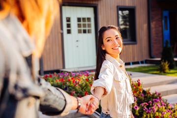 My love. Happy Asian woman smiling to her boyfriend while holding his hand
