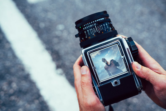 View Through The Camera A Naked Man With Tear Gas Mask On A Road.