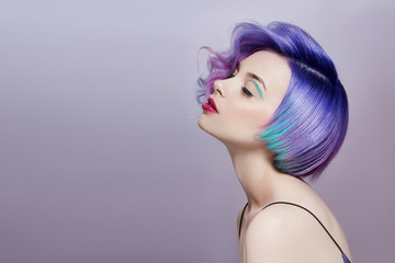 Portrait of a woman with bright colored flying hair, all shades of purple. Hair coloring, beautiful...