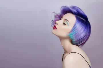 Foto op Canvas Portrait of a woman with bright colored flying hair, all shades of purple. Hair coloring, beautiful lips and makeup. Hair fluttering in the wind. Sexy girl with short  hair. Professional coloring © angel_nt