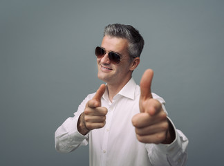 Cool friendly guy pointing at camera