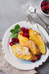 French sweet toasts with berries. Old gray vintage background. Top view. Copy space.