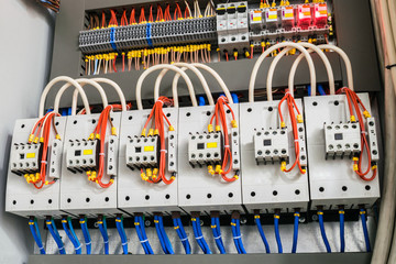 A modern open fuse box contains a lot of automata, connectors, relays, and magnet starters....