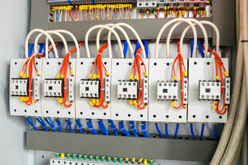 The mains electrical equipment is installed in an electrical box. Multicolored wires are connected...