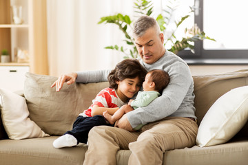 Fototapeta premium family, fatherhood and people concept - happy father with preteen and baby son at home