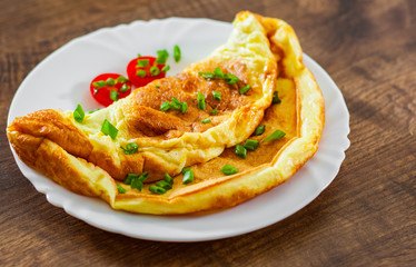 omelette in a white plate on wooden table