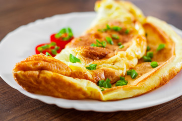 omelette in a white plate on wooden table