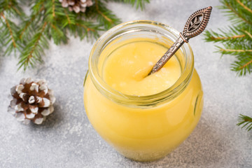 Homemade lemon curd in glass jars on the table. Concept Christmas