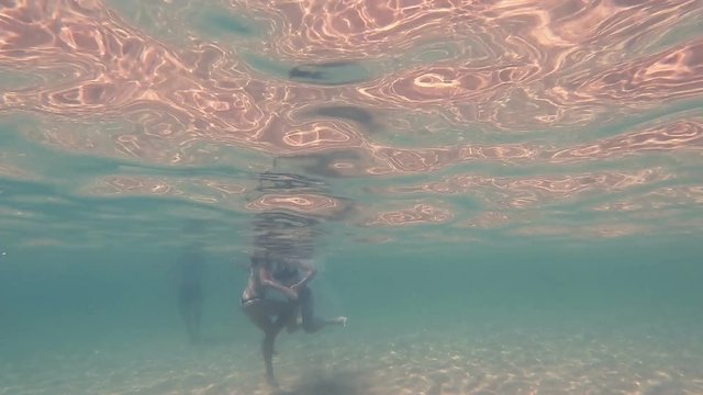 girls in thong play underwater