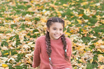 Small child with yellow leaves. Autumn leaves and nature. Happy childhood. School time. Happy little girl in autumn forest. Enjoying autumn day. Fresh air and good mood. Time to rest. Autumn beauty