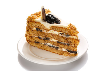 A piece of cake with honey and prunes, highlighted with a white background